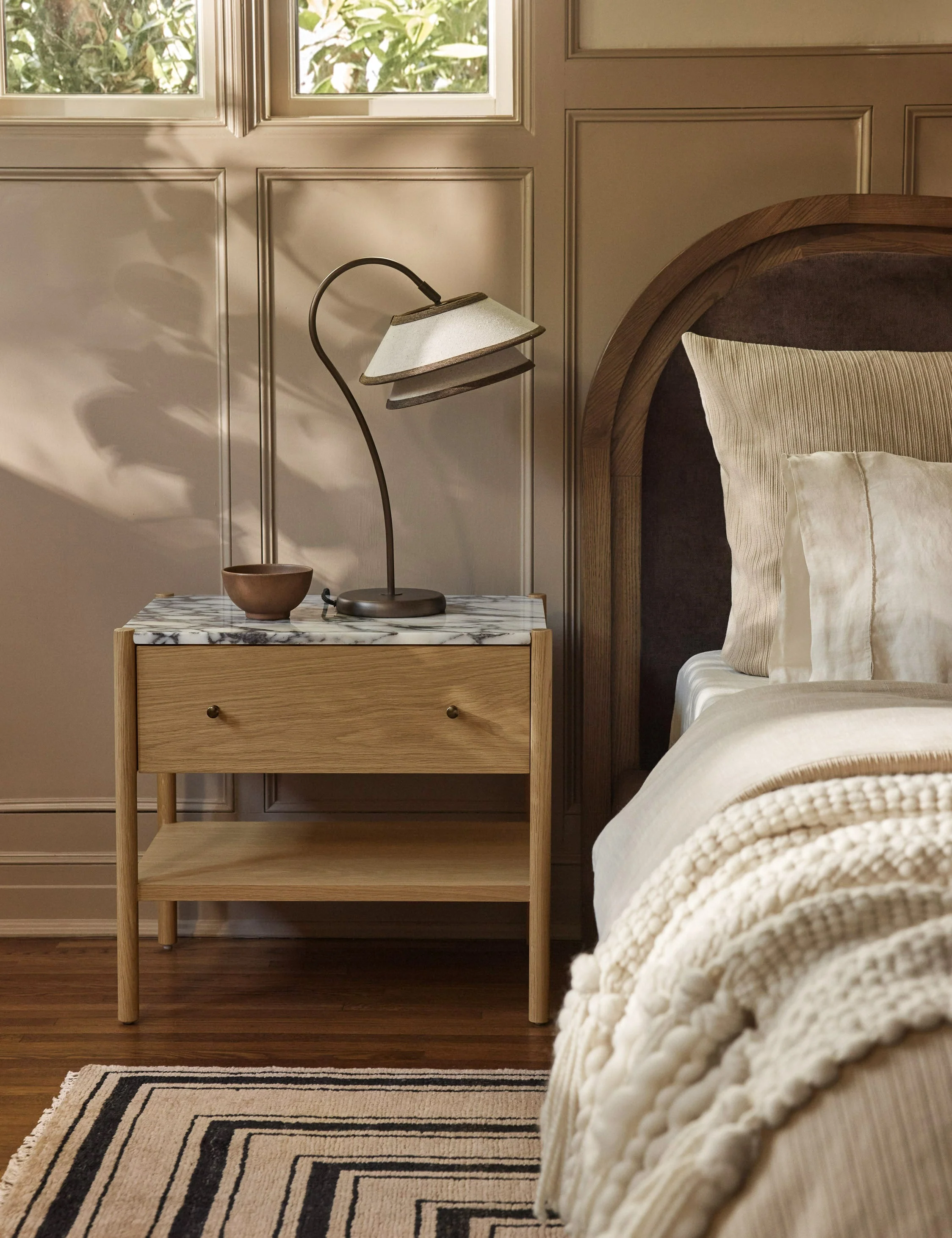 Nightstand Our nightstand brings a touch of polish to any bedroom edit. The wood frame showcases a beautiful natural grain, grounding the luxe