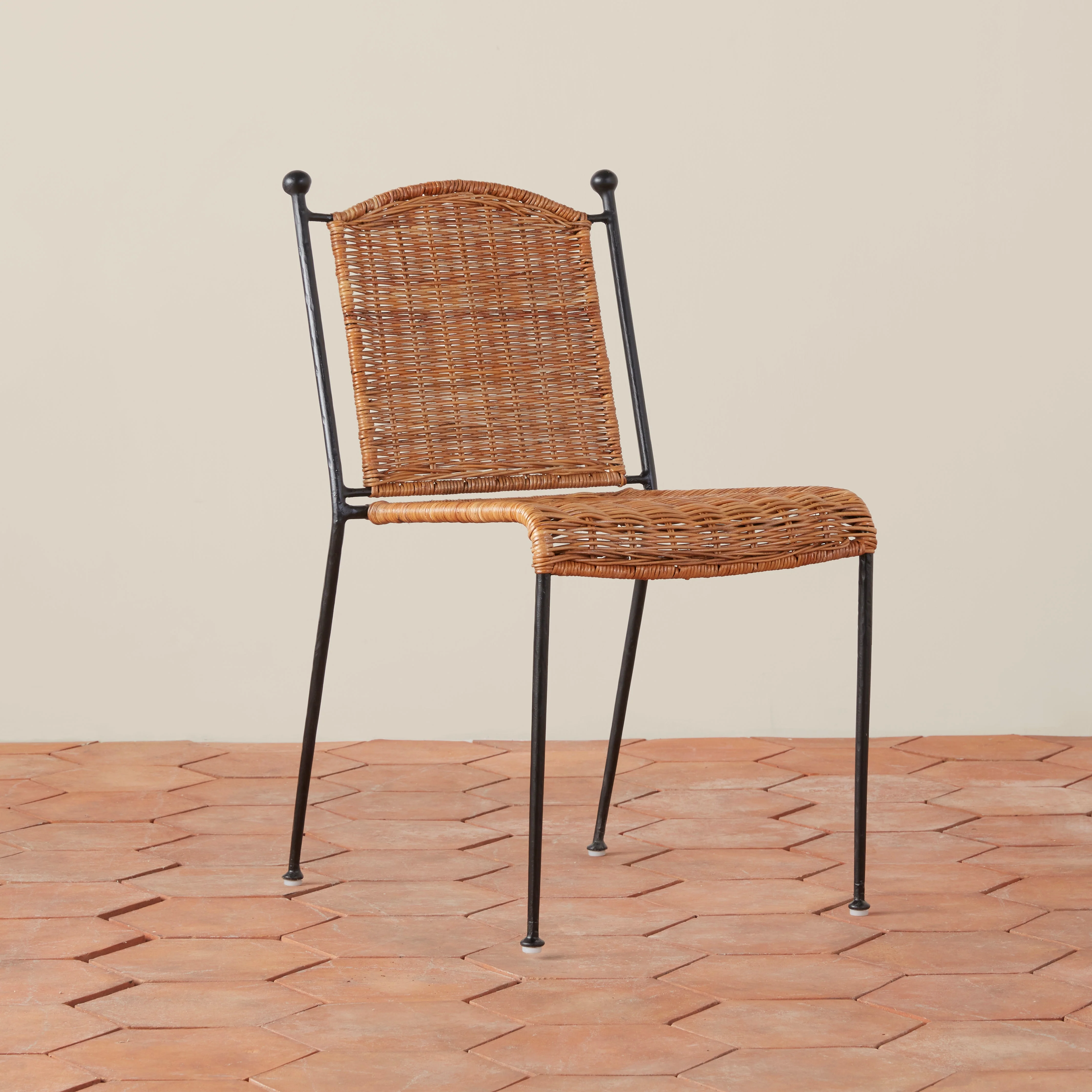 Dining Chair - crafted from sustainably sourced rattan and hand hammered wrought iron, this vintage inspired, stackable dining chair easily...