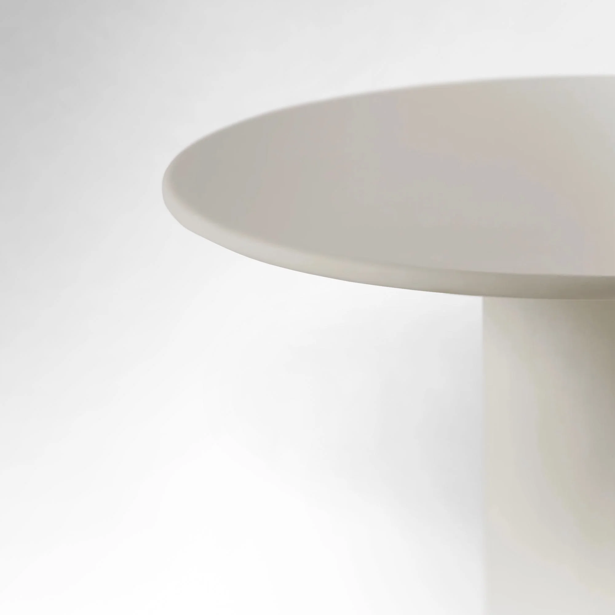 Round Dining Table in Cement - Microcement - sustainable low-density MDF - and a solid spruce wood structure accompanied by a fromager covering for