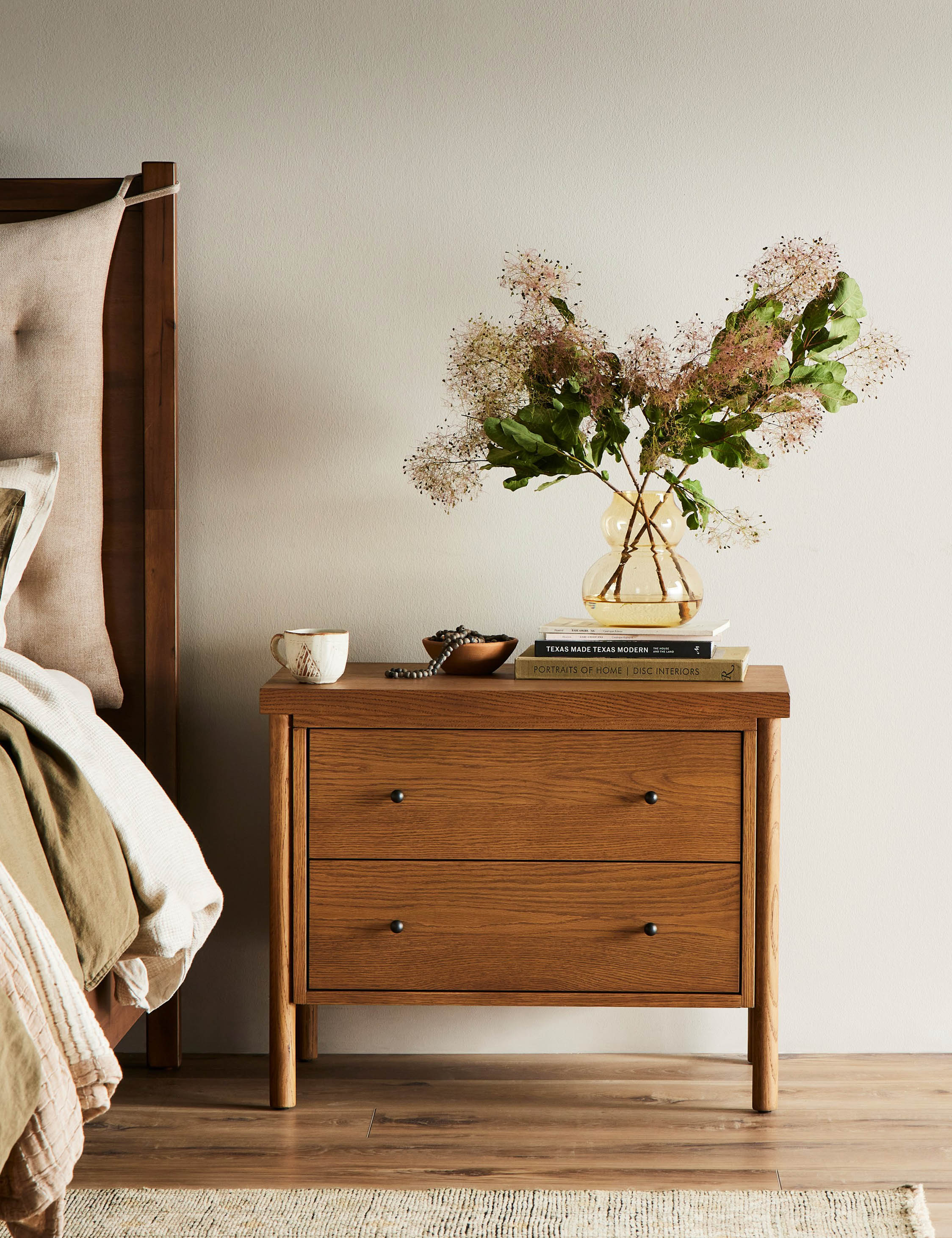 Nightstand The nightstand brings transitional appeal to oak. Rounded legs hold a clean-lined frame in a warm finish that showcases the natural