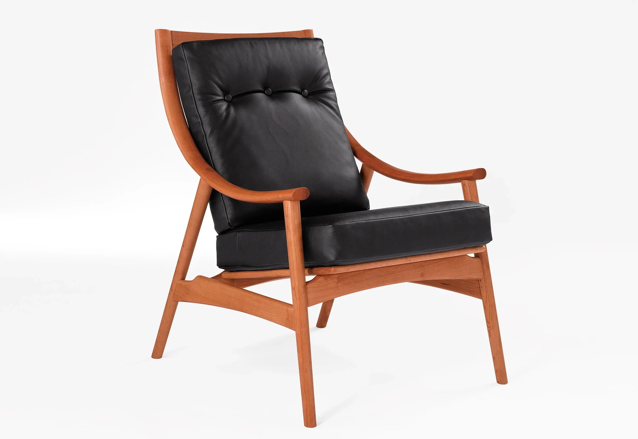 Lounge Chair - Designed with sweeping, curved arms, slender spindles along the back, and slender, gently raked legs
