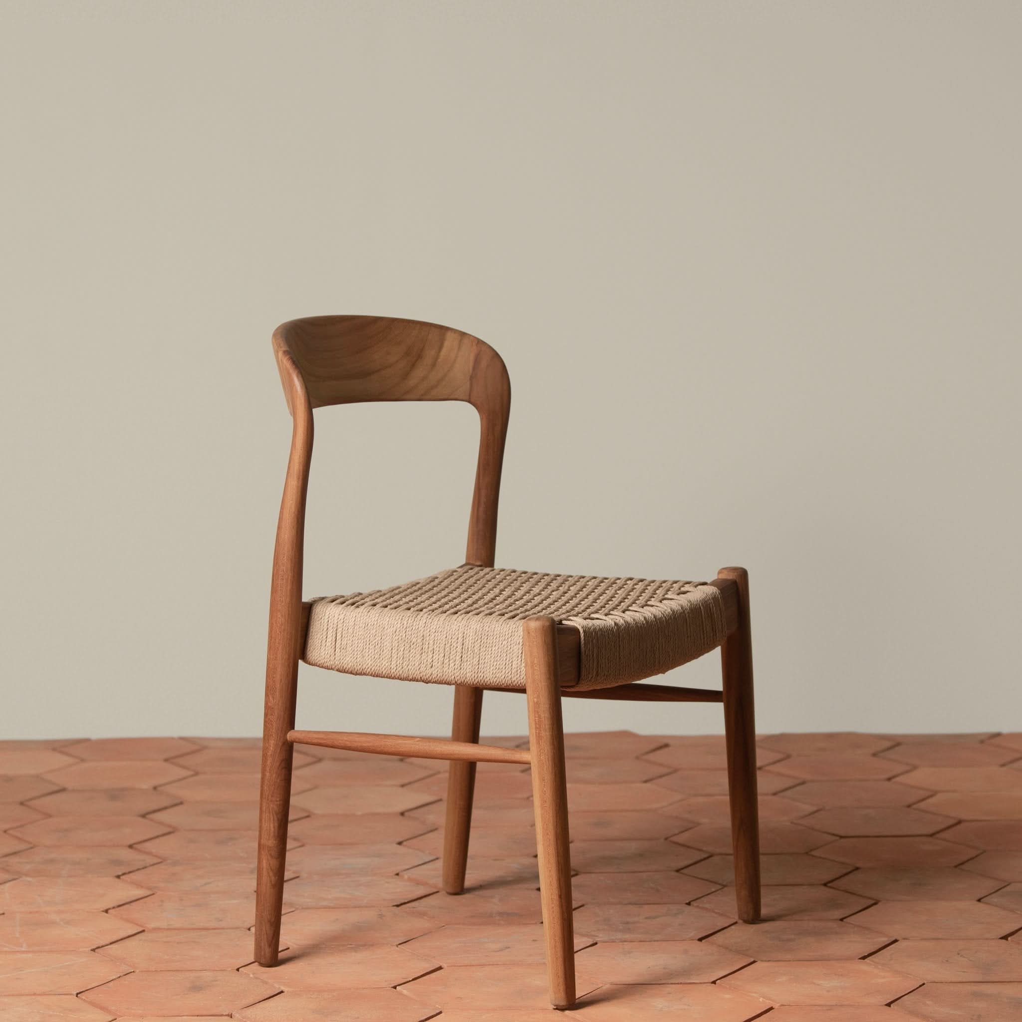 Side Chair - Available in multiple finishes, the ’s sculptural lines, curved back, and generously sized hand- loom seat balance form and texture...