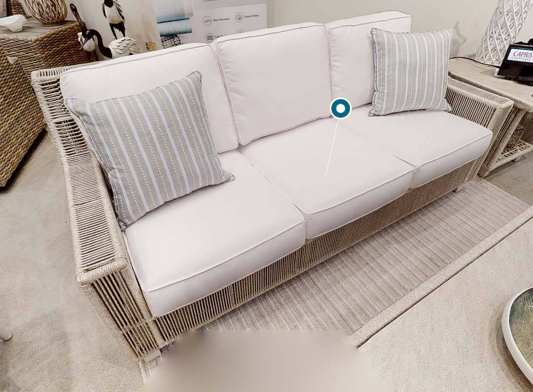 Luxe Outdoor Wicker Sofa with White Cushions and Striped Accent Pillows