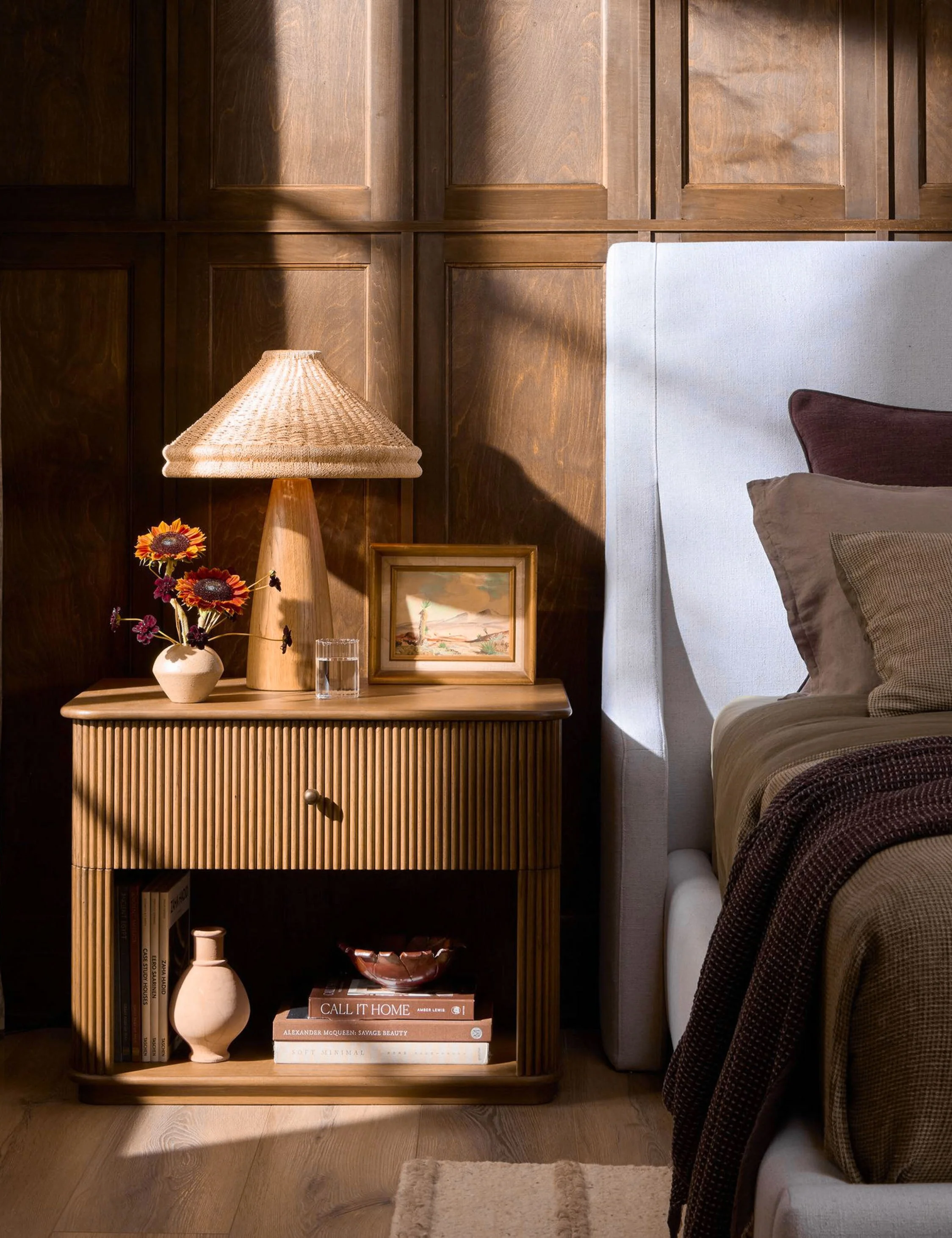 Nightstand - The nightstand offers elevated defined by reeded detailing and a grounded plinth base