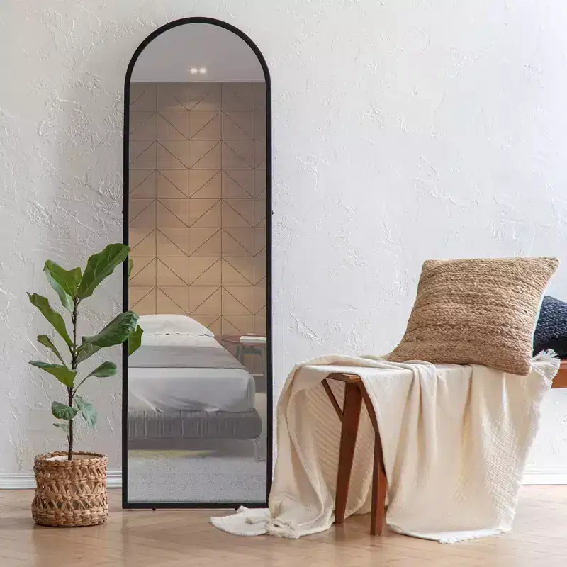 Black Arched Mirror: 60-inch modern floor mirror, metal frame, freestanding, 18 inches wide.